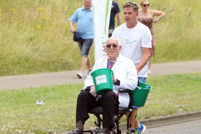 Corby Carnival: Corby: Corby Carnival parade
Paul Marlow with Vic Hardy from Lakelands Hospice
Saturday 12th July 2014 NNL-140713-182156009