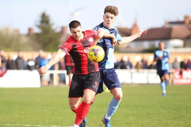 Dan Holman battles for possession for the Poppies