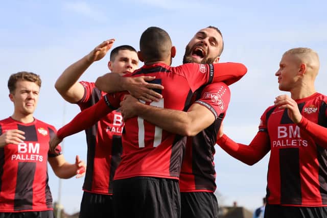 Rhys Hoenes takes the congratulations after he scored Kettering Town's first goal from the penalty spot to send them on their way to a 2-0 success over St Neots Town. Pictures by Peter Short