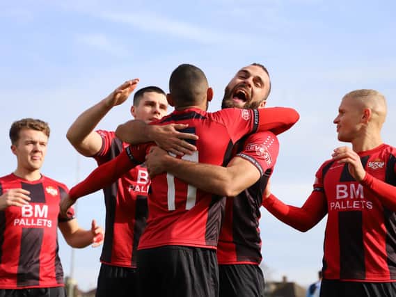 Rhys Hoenes takes the congratulations after he scored Kettering Town's first goal from the penalty spot to send them on their way to a 2-0 success over St Neots Town. Pictures by Peter Short