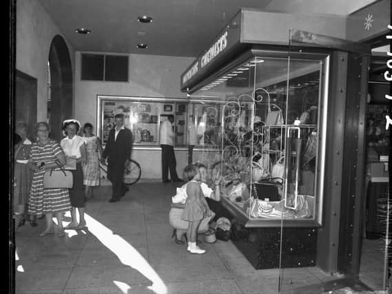 A mother and her daughter window shopping in Boots new store on the corner of Gold Street and Drapery, Northampton, on September 12, 1959