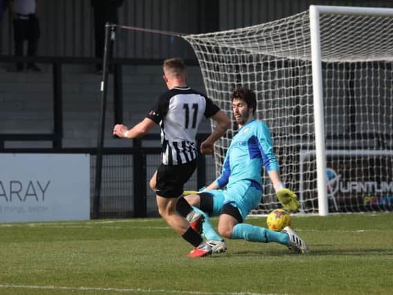 Jordon Crawford scores Corby Town's opening goal in their 3-1 win over Berkhamsted at Steel Park. Pictures by Alison Bagley