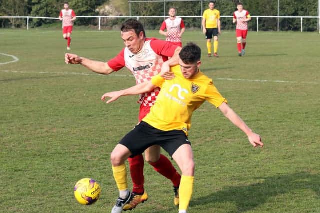 Rothwell Corinthians and Harborough Town battle for possession