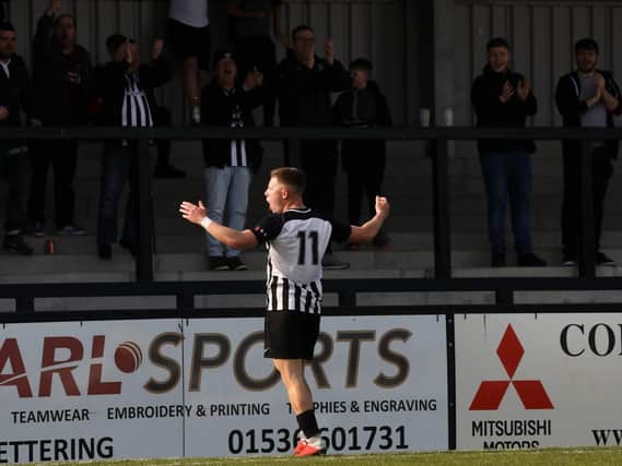 Jordon Crawford celebrates his goal in front of the Corby Town fans during the 3-1 victory over Berkhamsted at Steel Park. Pictures by Alison Bagley
