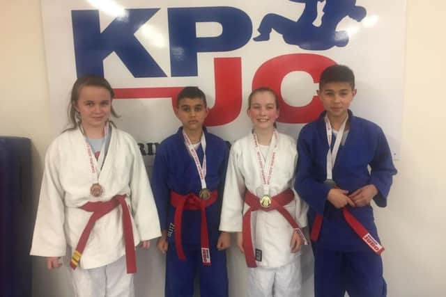 Kettering Premier Judo Club members, from left, Nicole Peters, Yacine Benhidour, Beata Binder and Riyad Benhidour, show off their medals