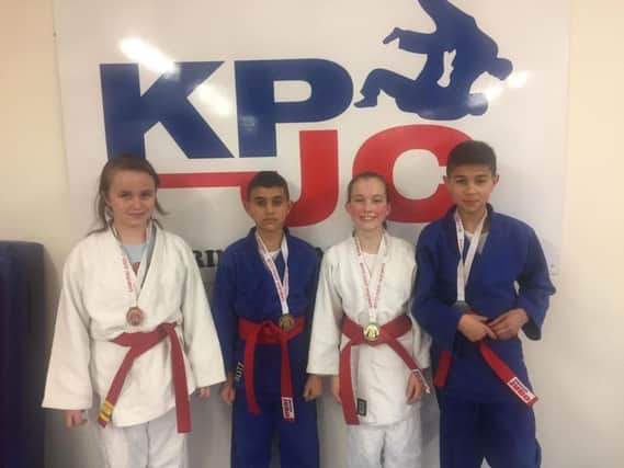 Kettering Premier Judo Club members, from left, Nicole Peters, Yacine Benhidour, Beata Binder and Riyad Benhidour, show off their medals