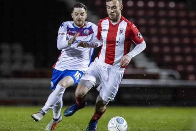 AFC Rushden & Diamonds' John Dean challenges Brackley's Shane Byrne