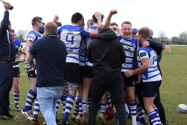 The celebrations begin after Kettering won the Midlands One East title with a 47-8 victory at local rivals Wellingborough. Pictures by Alison Bagley