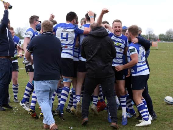 The celebrations begin after Kettering won the Midlands One East title with a 47-8 victory at local rivals Wellingborough. Pictures by Alison Bagley