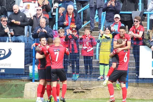 The Kettering players celebrate their goal
