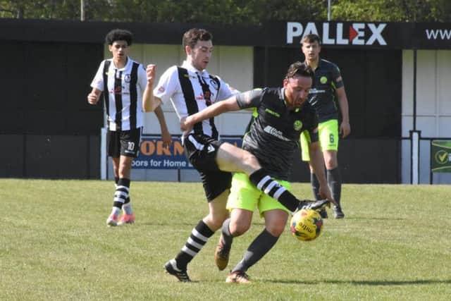Joe Curtis battles for possession for AFC Rushden & Diamonds during their 5-0 defeat at Coalville Town on Saturday. Picture courtesy of HawkinsImages