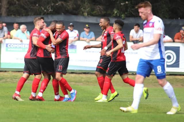 Lathaniel Rowe-Turner takes the congratulations after he scored Kettering Town's goal in the 1-0 win at local rivals AFC Rushden & Diamonds. Pictures by Peter Short
