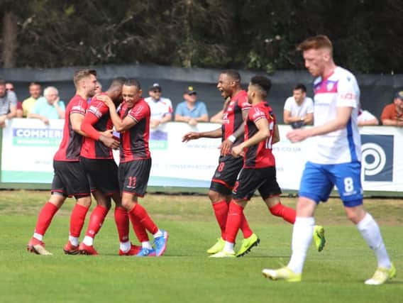 Lathaniel Rowe-Turner takes the congratulations after he scored Kettering Town's goal in the 1-0 win at local rivals AFC Rushden & Diamonds. Pictures by Peter Short