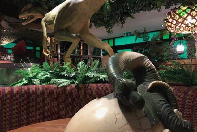 A dinosaur hatches from its shell at Jurassic Grill NNL-190425-211303005