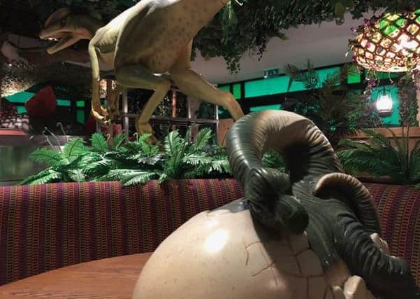 A dinosaur hatches from its shell at Jurassic Grill NNL-190425-211303005
