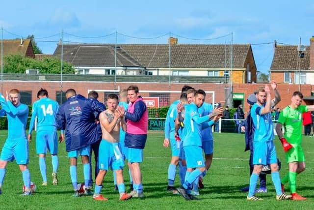 The Corby Town players show their appreciation to the travelling supporters after their 2-1 victory at Kidlington. Picture by Jim Darrah