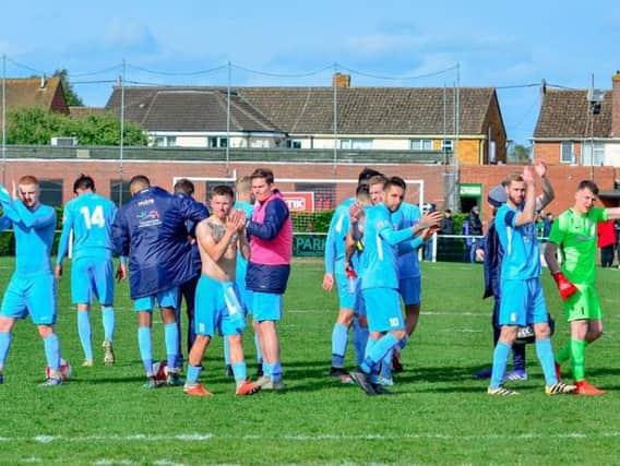 The Corby Town players show their appreciation to the travelling supporters after their 2-1 victory at Kidlington. Picture by Jim Darrah