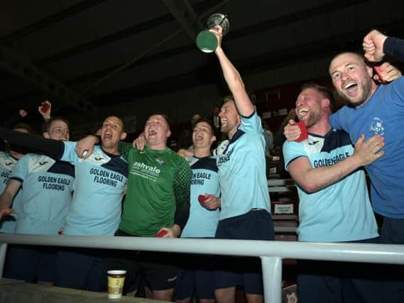 Kettering Nomads captain Jim Whittemore lifts the NFA Junior Cup after his team beat Blisworth 2-0 in the final at Sixfields. Picture by Dave Ikin