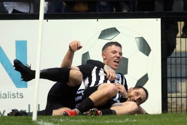 Jordon Crawford celebrates with Steve Diggin after Corby Town's second goal in their 5-3 victory over Bedford Town in the play-off semi-final. Pictures by Alison Bagley