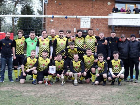Corby Ravens show off their silverware after they won three trophies during an unbeaten season. Pictures by Alison Bagley