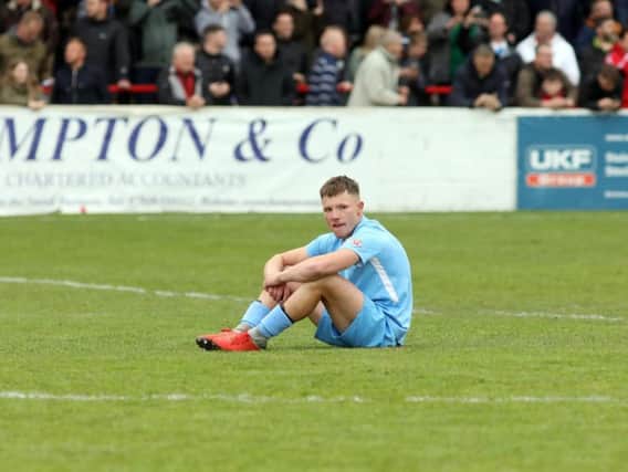 Jordon Crawford cuts a lonely figure after the final whistle as Corby Town missed out on promotion after their 4-3 defeat at Bromsgrove Sporting in the play-off final. Pictures by Alison Bagley