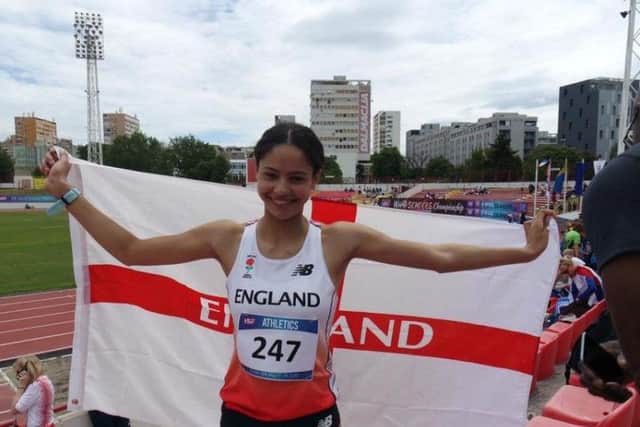 Emily Williams flies the flag after she was crowned ISF 800m World Schools champion in Croatia