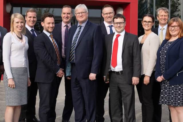 Members of the Bray & Bray team, with Senior Partner Tim Gladdle (centre), at the firms new offices at Corby Enterprise Centre.