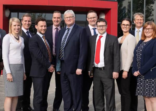 Members of the Bray & Bray team, with Senior Partner Tim Gladdle (centre), at the firms new offices at Corby Enterprise Centre.