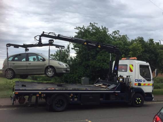 A Renault is lifted on to a lorry after police found it to be untaxed