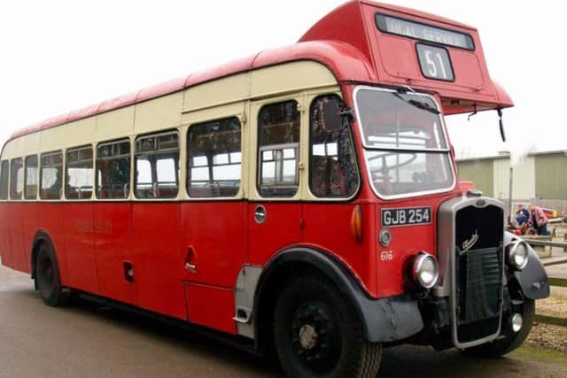The vintage bus transporting people to and from the train station.