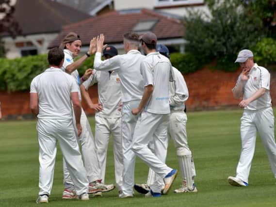 Old Northamptonians celebrate a wicket during their Premier Division win over Brigstock. Pictures by Dave Ikin