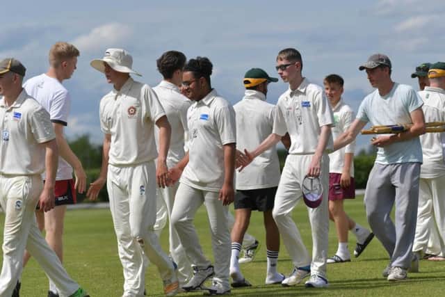 The two sets of players shake hands after Overstone Park 2nd enjoyed a five-wicket win over Finedon Dolben 3rd in Division Four