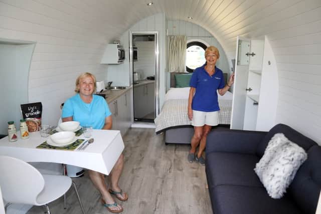 Owner Sarah Singlehurst and manager Jackie Creasey inside one of the glamping pods