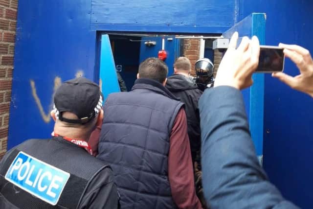 Officers break into the rear with the big red key.