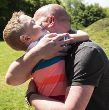 Blood donor Andrew and recipient hugging when they met
