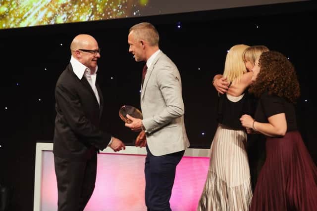 Headteacher John Wayland picks up the award.