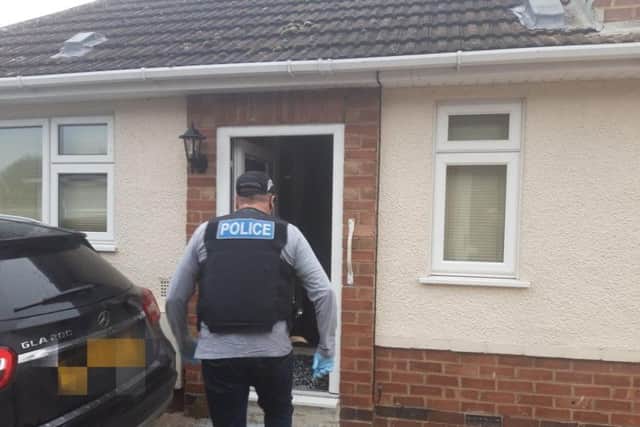 Officers smash their way into the Gotch Road property.