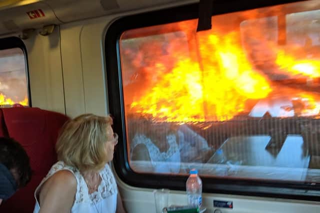 Rail passengers watched on as they passed the blaze. Picture by Sarah Cole.