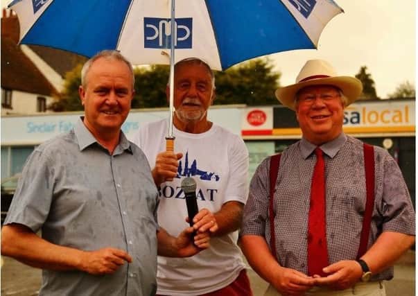 Leader of Wellingborough Council, Martin Griffiths, Chairman of Bozeat Parish Council, Brian Gibbins and Deputy Leader of the Council, Tom Partridge-Underwood at Bozeat Fete, following the handing over of a £1 for the transfer of the village green. 
Saturday 6th July 2019 NNL-190907-145929005