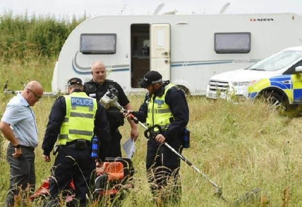 Police at the scene. PHOTO BY ANDREW CARPENTER