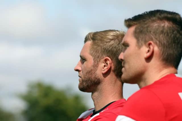 Corby joint-manager Gary Mulligan and assistant-boss Elliot Sandy watch on from the sidelines
