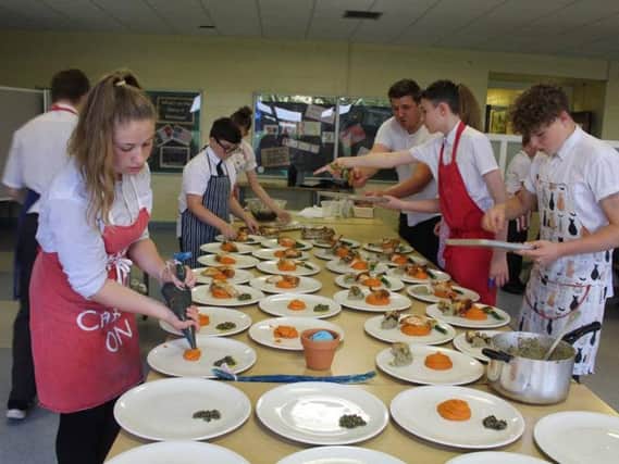 Students help prepare the feast.