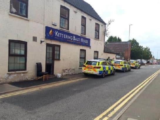 Police at the curry house two weeks ago.