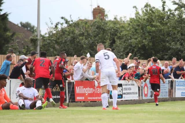 Joel Carta heads off to celebrate after he brought the Poppies level