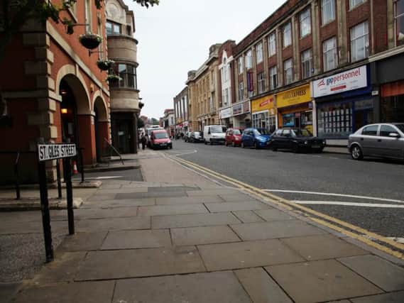 A woman and her friend were assaulted by three men in St Giles Street.