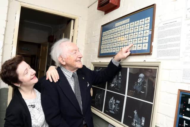 Eugene, with his daughter Julia, pointing to a record of his supposed death.