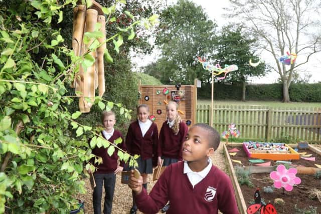 Nathan, 10, tests the wind chimes
