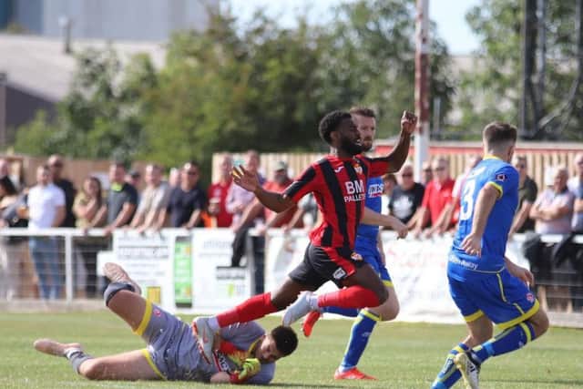 Dan Nti goes down under a challenge from Alfreton goalkeeper Jack Atkinson, which earned Kettering a first-minute penalty