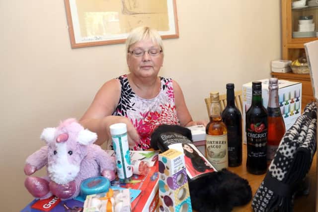 Elaine sorts through some of the items donated for the raffle which will be held at her Macmillan Coffee morning event
