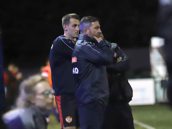 Nicky Eaden and Luke Graham watch on from the sidelines during what proved to be the formers final game in charge of Kettering Town as they slumped to a 2-1 FA Cup replay defeat at Sutton Coldfield Town. Picture by Peter Short